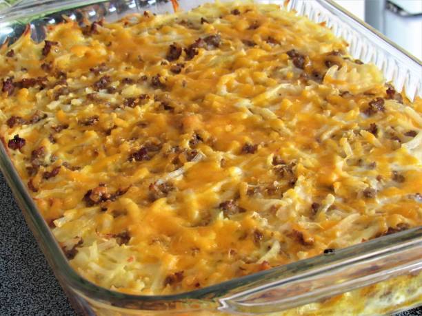 A baked casserole dish with a cheesy topping and ground meat mixed with hash browns