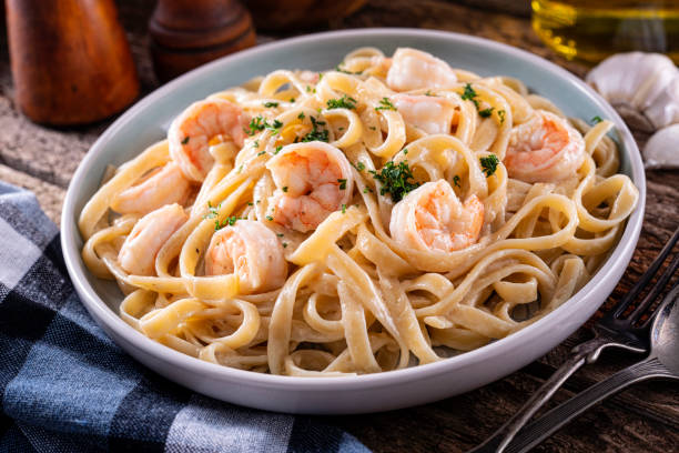 Plate of shrimp fettuccine pasta topped with parsley