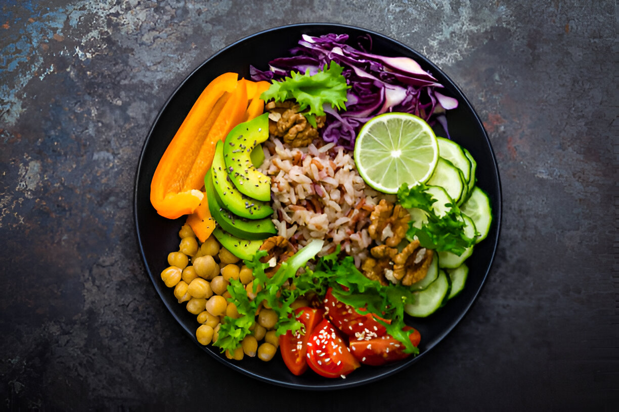 A vibrant bowl of healthy food featuring rice, vegetables, and nuts.