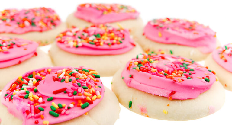 Colorful sugar cookies with pink frosting and sprinkles.