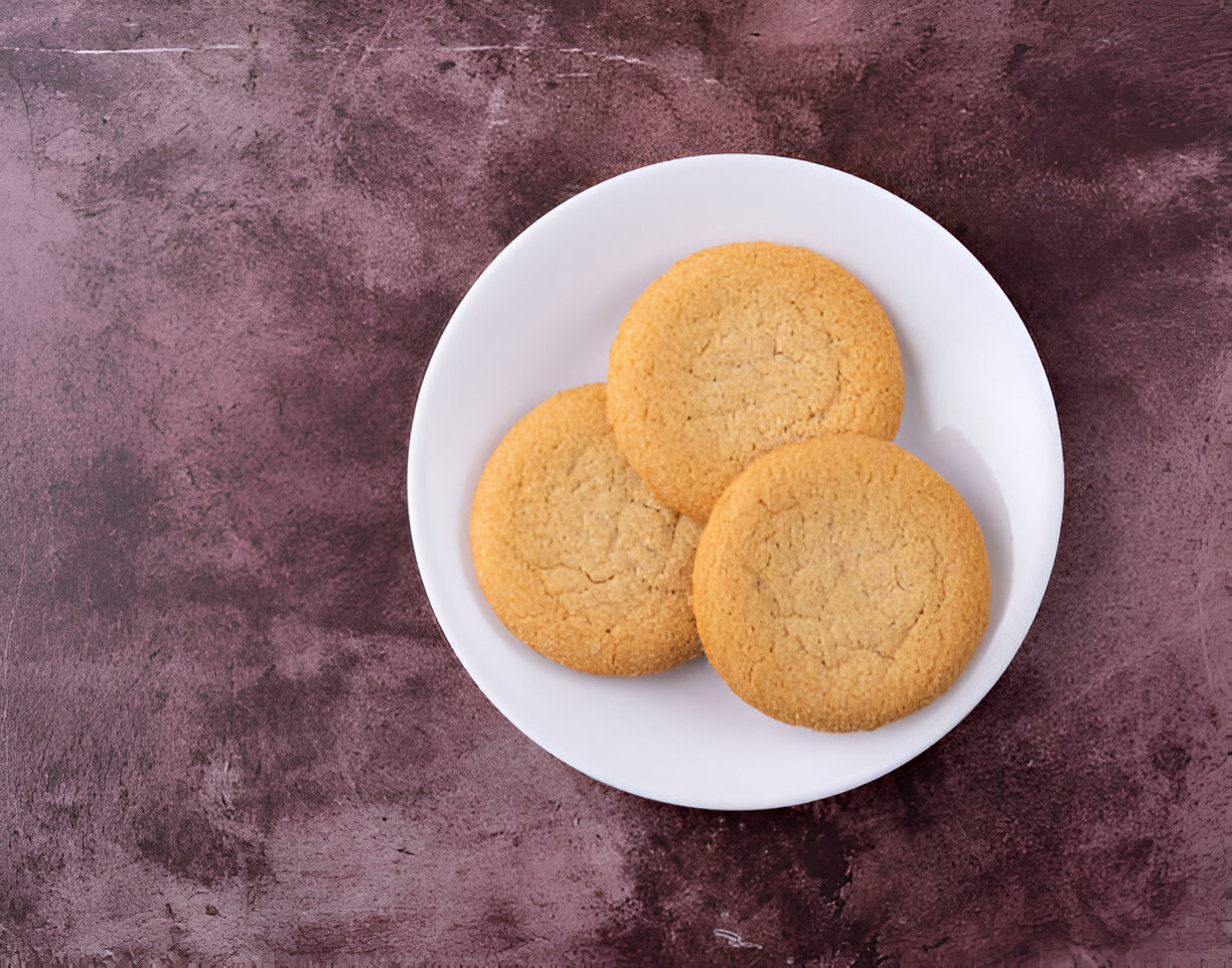 Three round cookies on a white plate