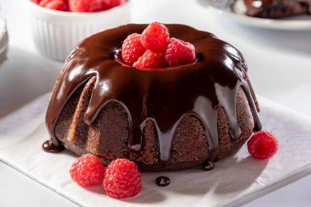 A delicious chocolate bundt cake topped with fresh raspberries and chocolate ganache.