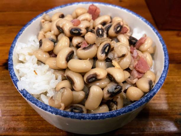 A bowl of black-eyed peas served over white rice.