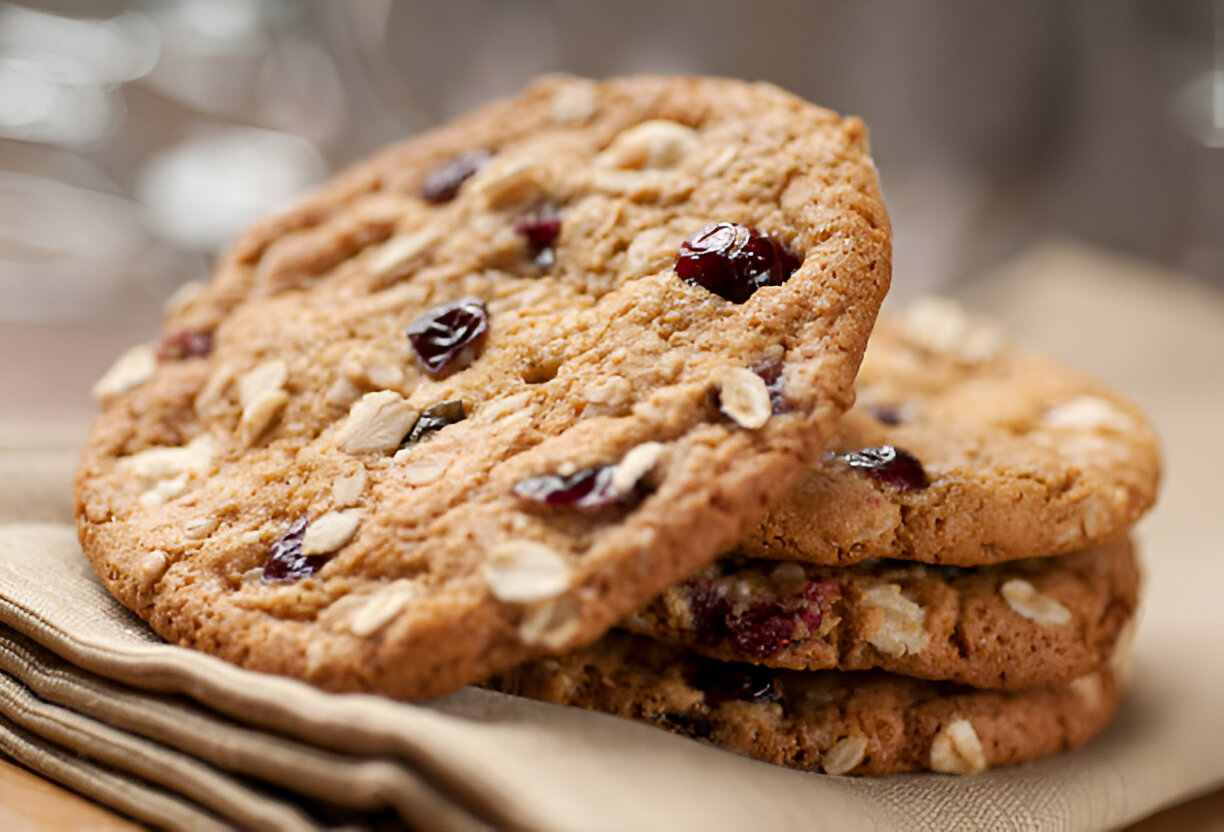 Stack of oatmeal cookies with cranberries on a textured napkin