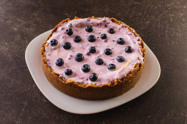 A blueberry cheesecake on a white plate.