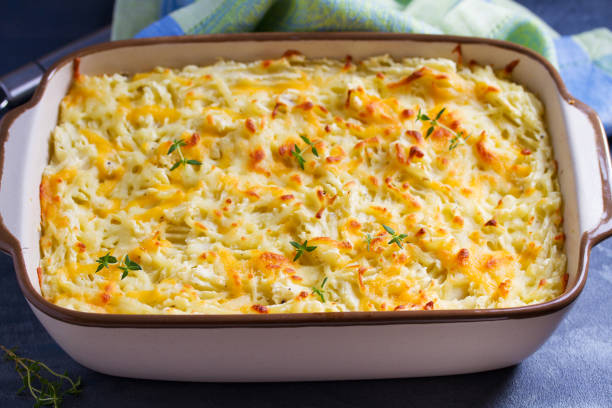 Baked dish topped with golden brown cheese and fresh herbs