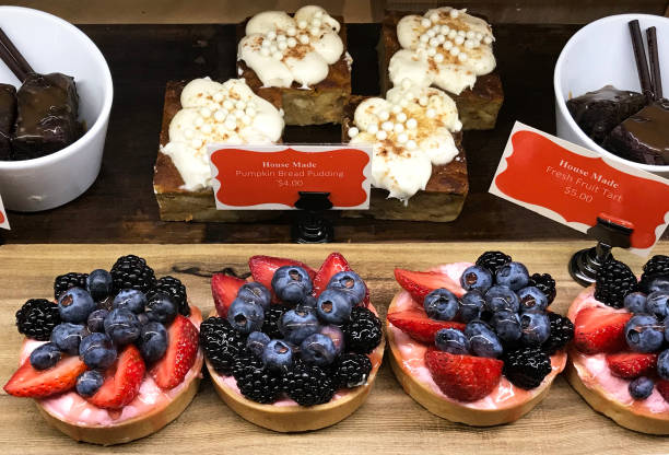 Colorful desserts including a pumpkin bread pudding and fresh fruit tarts topped with berries.