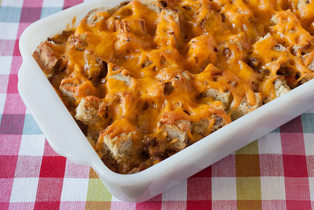 A casserole dish of cheesy baked bread with a golden-brown top.