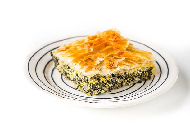 A slice of savory spinach pie on a round plate