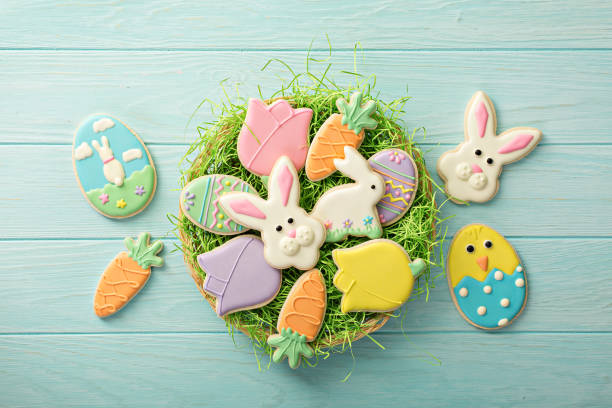 Colorful decorated Easter cookies arranged in a nest of green grass