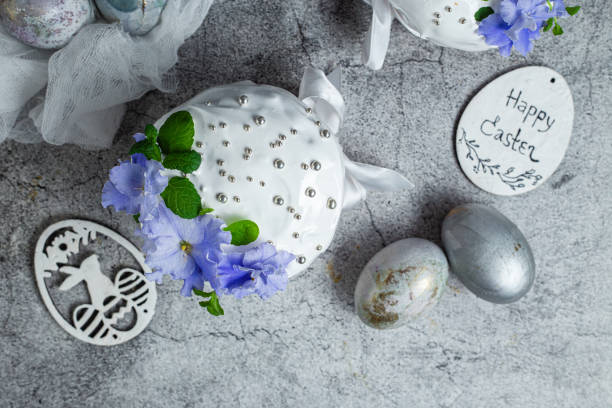 Decorative Easter eggs and floral arrangements on a textured surface.