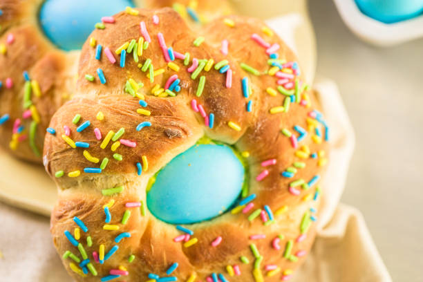 A freshly baked sweet bun topped with colorful sprinkles and featuring a blue cream filling