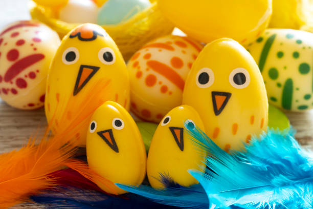 Colorful Easter eggs decorated as cute chicks with vibrant feathers.