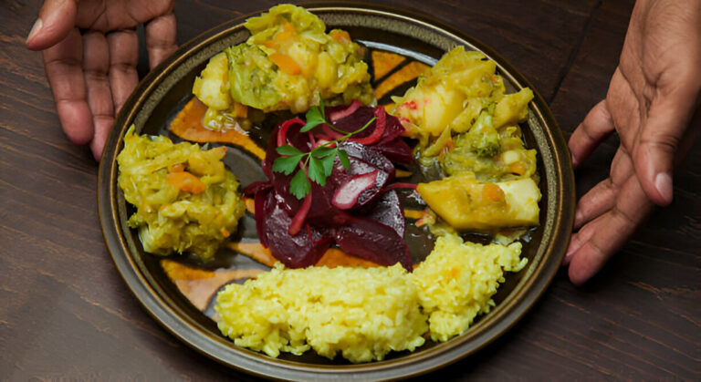 A beautifully arranged plate of mixed vegetables and rice, garnished with herbs.