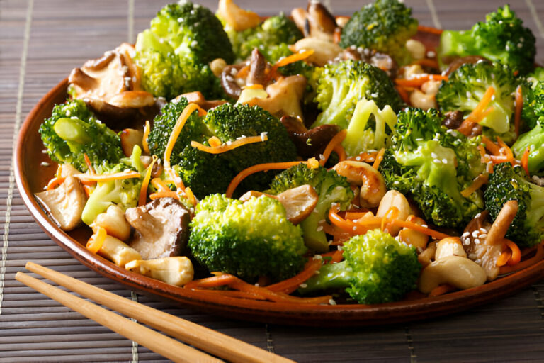 A colorful vegetable stir-fry featuring broccoli, carrots, and mushrooms on a brown plate with wooden chopsticks.