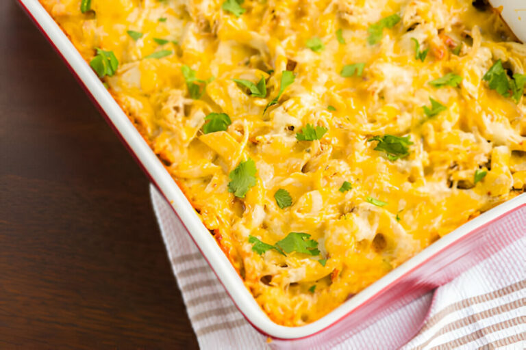 Baked pasta casserole topped with melted cheese and fresh herbs