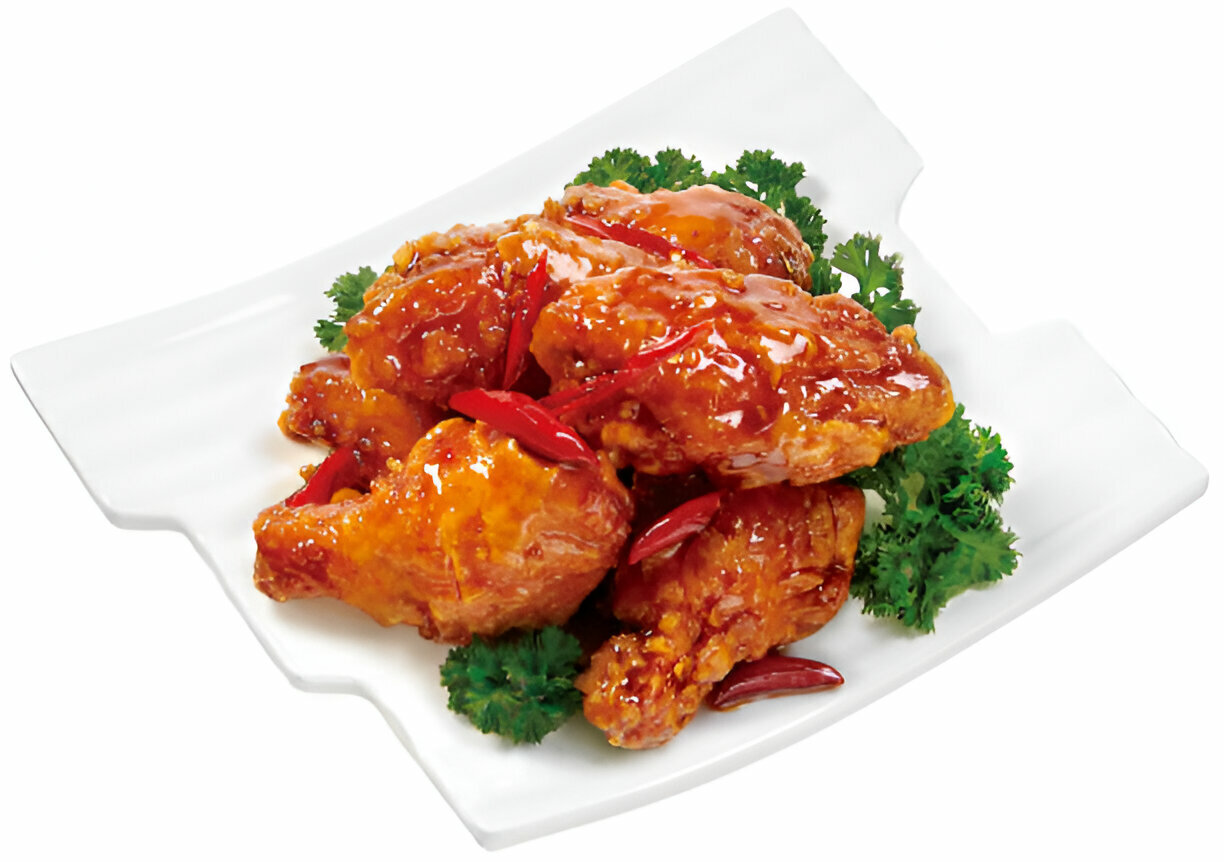 Deliciously glazed chicken wings garnished with red chili peppers and parsley on a white plate