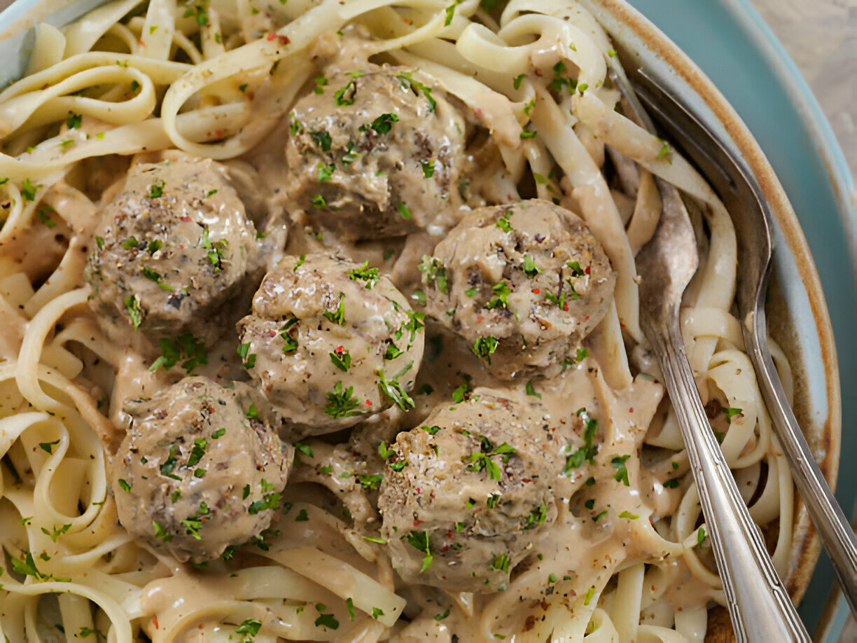 Easy Garlic Butter Meatballs served over creamy Parmesan linguine