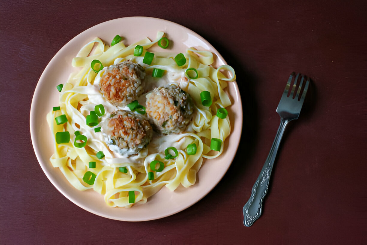 Easy Garlic Butter Meatballs served over creamy Parmesan linguine